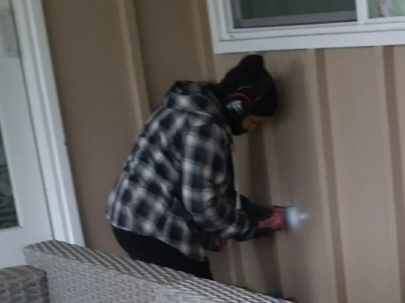Professional electrician installing an exterior outlet in Orchards