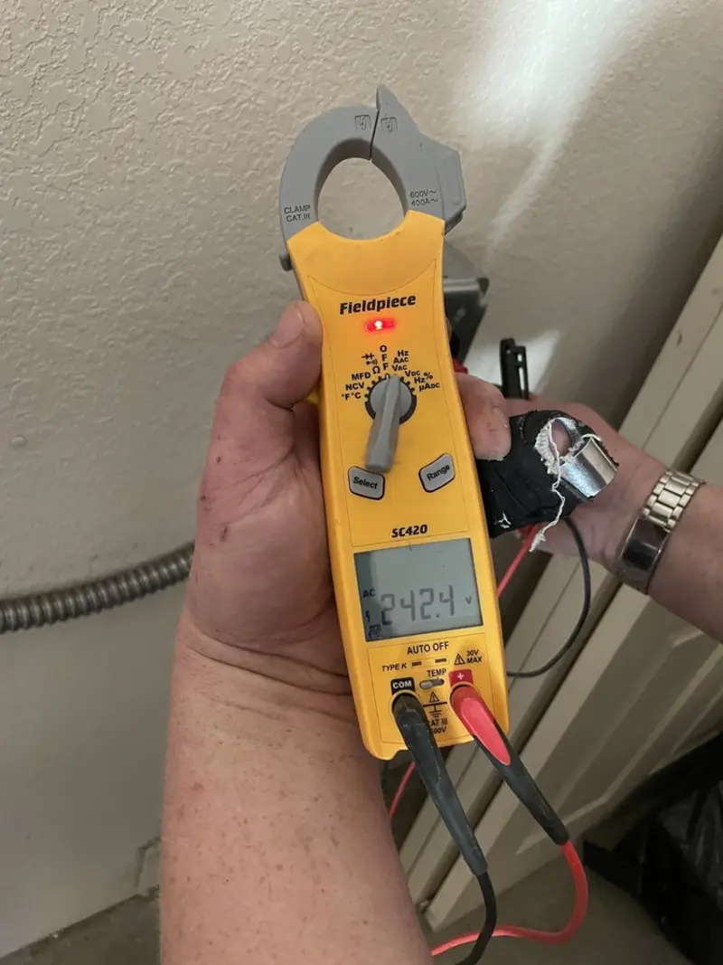 Voltage testing with clamp meter during Outlet Installation in Orchards
